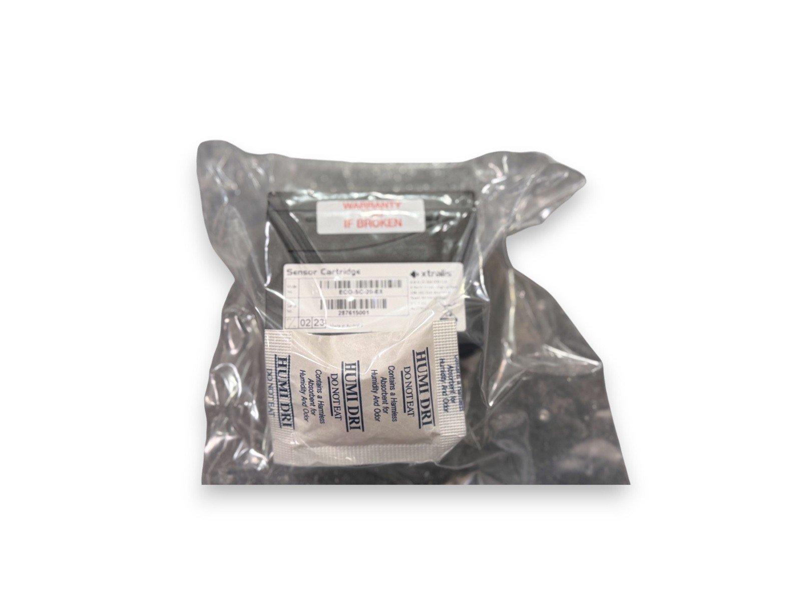Sealed fire alarm sensor cartridge with humidity absorber packet, labeled for safety and warranty.