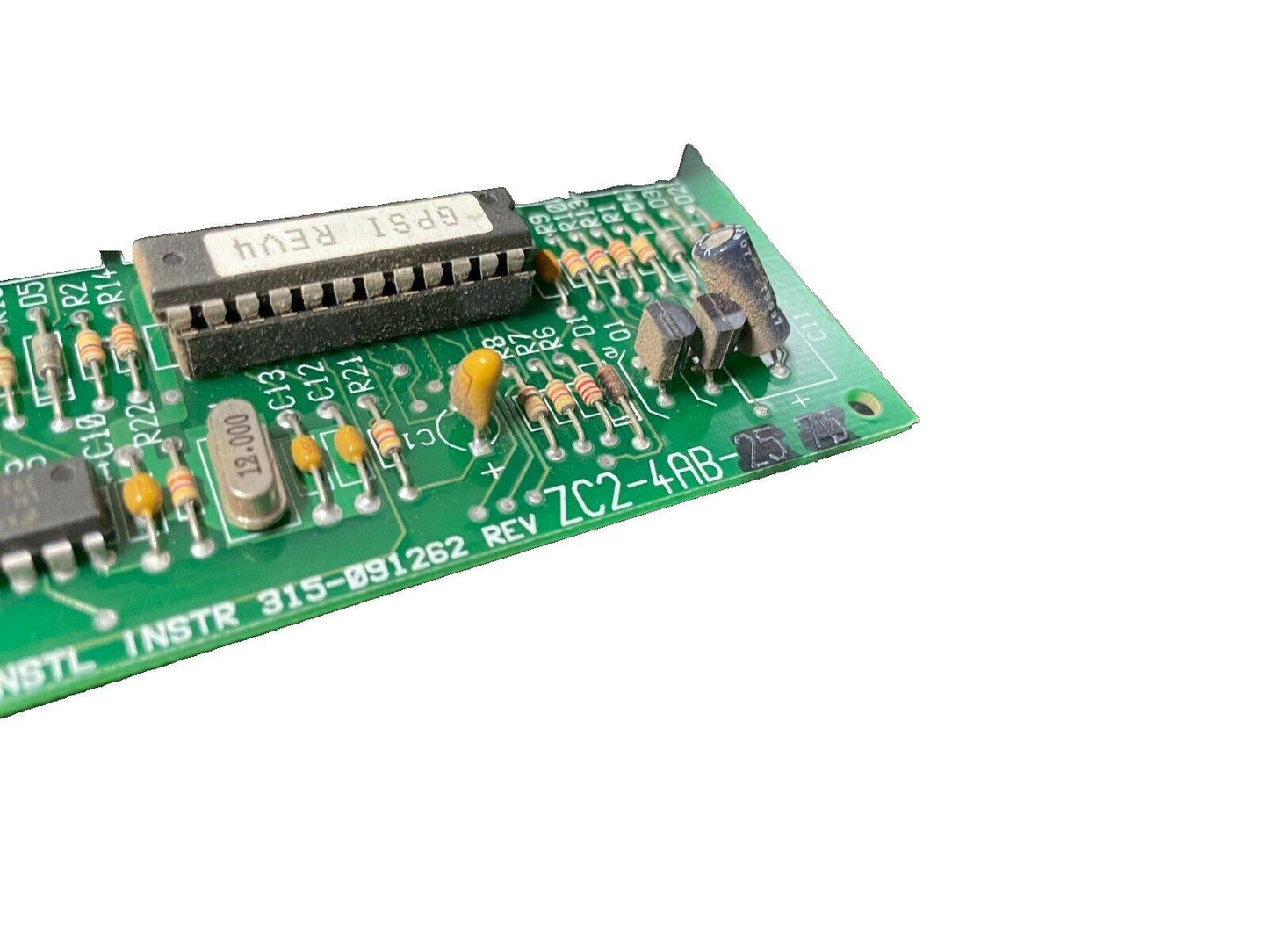Green fire alarm control board with resistors, capacitors, and IC chip, model ZC2-4AB-25