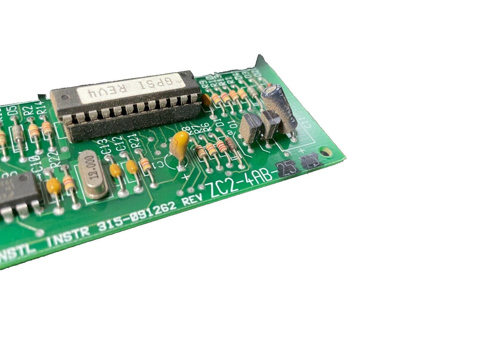 Green fire alarm control board with resistors, capacitors, and IC chip, model ZC2-4AB-25