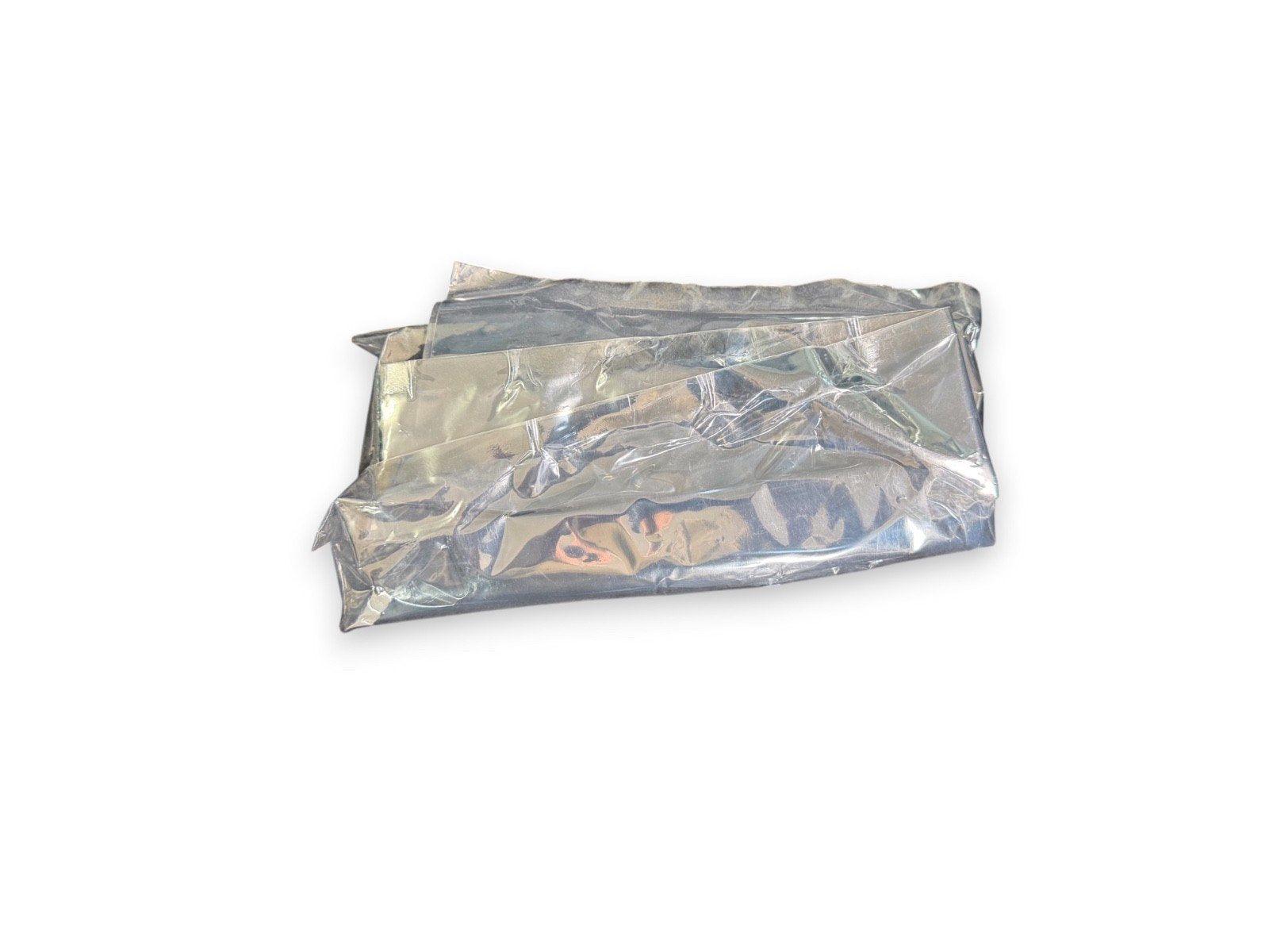 Crisp, crinkled silver fire blanket packaged for safety use in fire alarm systems