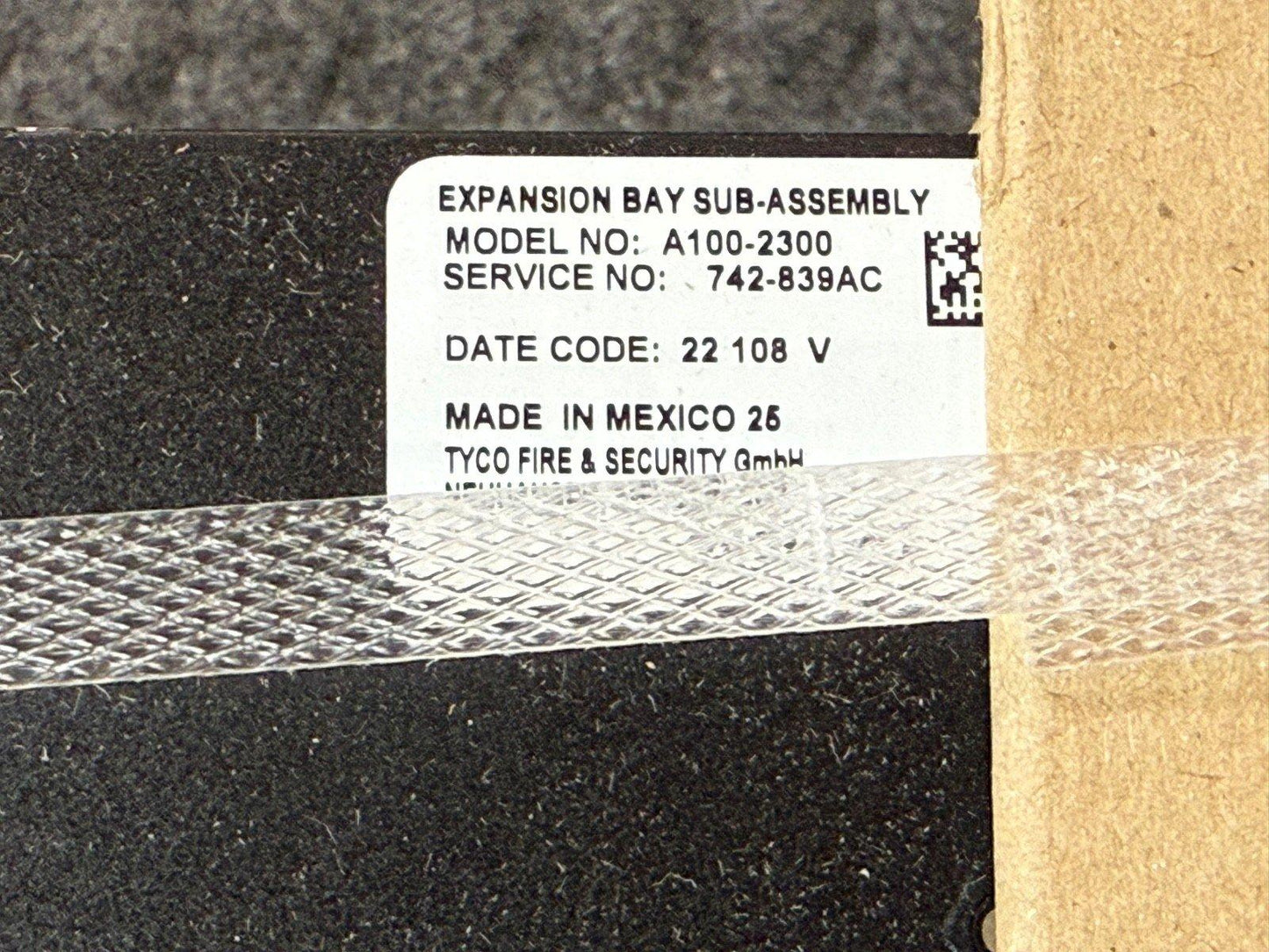 Tyco Expansion Bay Sub-Assembly A100-2300 fire alarm component, model label with service number and Mexico manufacturing details
