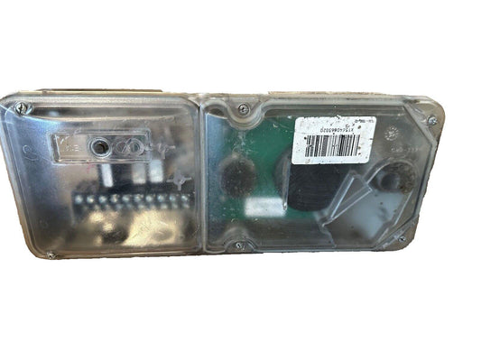 Used fire alarm strobe light with clear cover and internal components visible