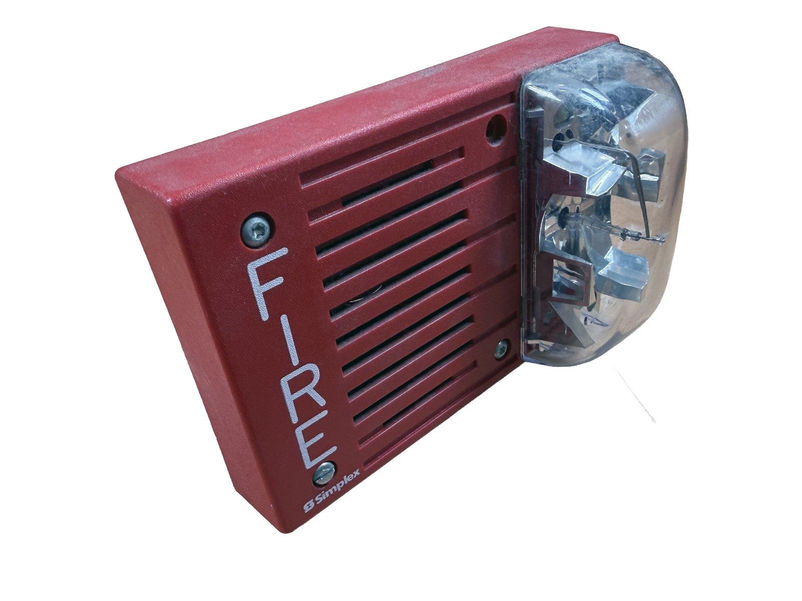 Red Simplex fire alarm with strobe light and 'FIRE' label for commercial safety systems