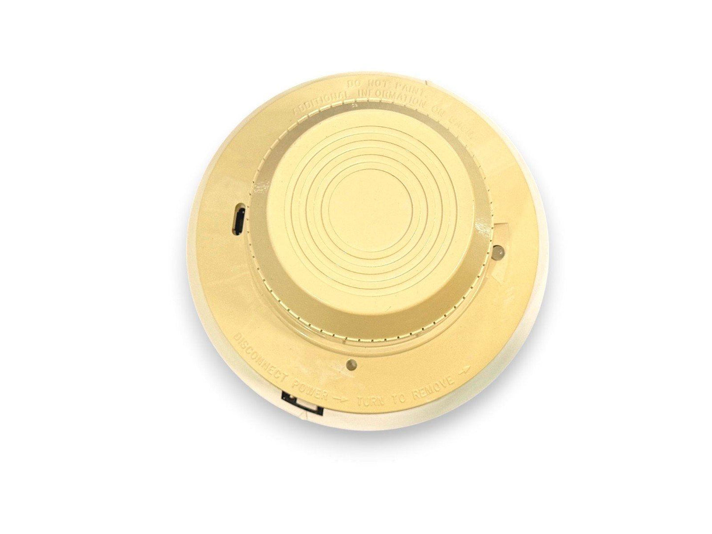 Round fire alarm detector with mounting base, safety instructions visible, for commercial or residential use