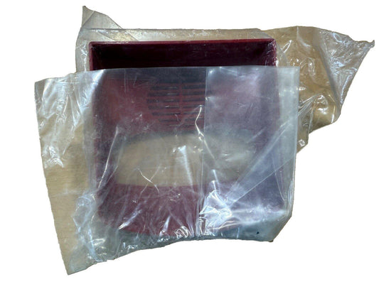 Red fire alarm speaker strobe in plastic wrap, used fire safety equipment