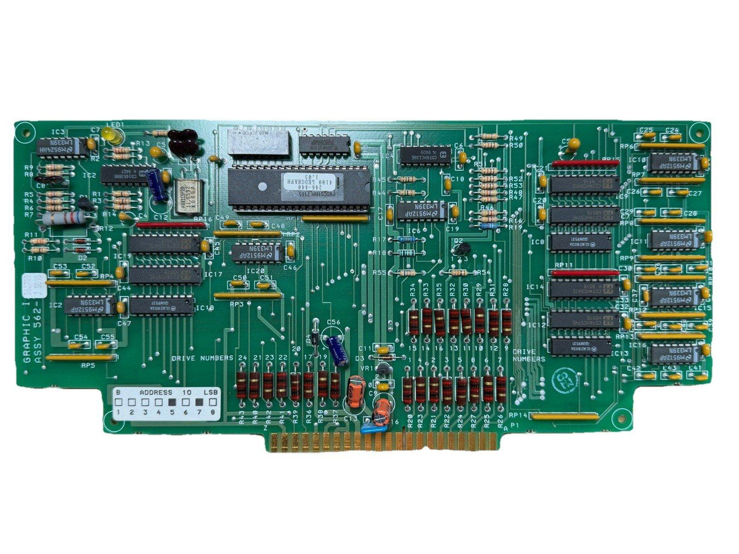 Green fire alarm control panel circuit board with ICs, resistors, and connectors for fire safety systems