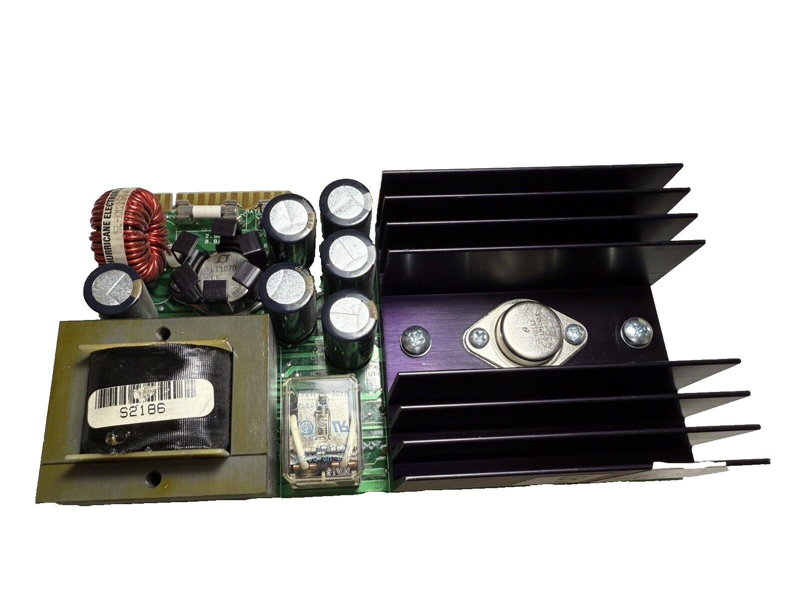 Fire alarm control panel circuit board with capacitors, heatsink, and transformer for fire safety systems