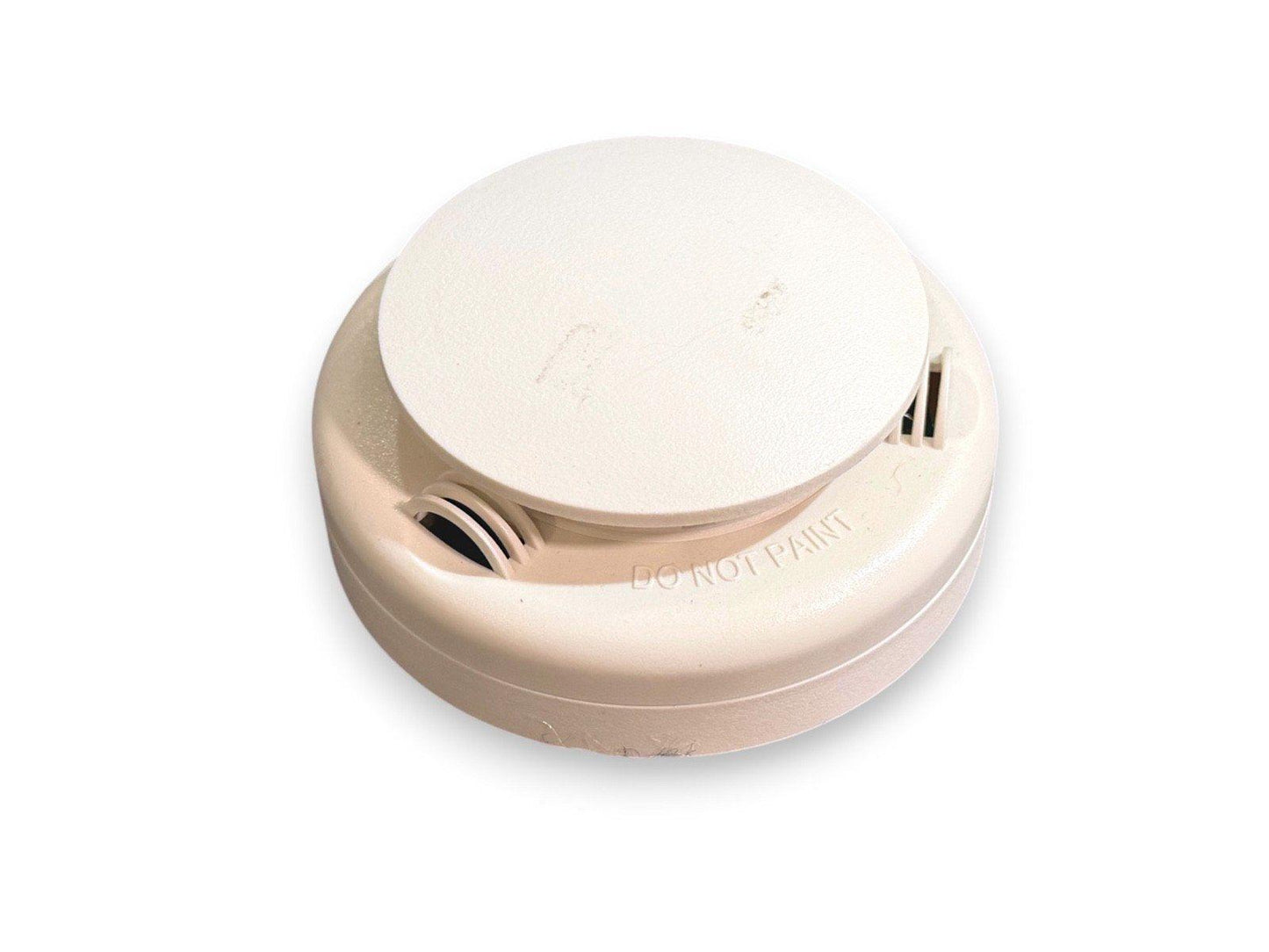 Beige smoke detector with 'DO NOT PAINT' label, fire alarm safety device