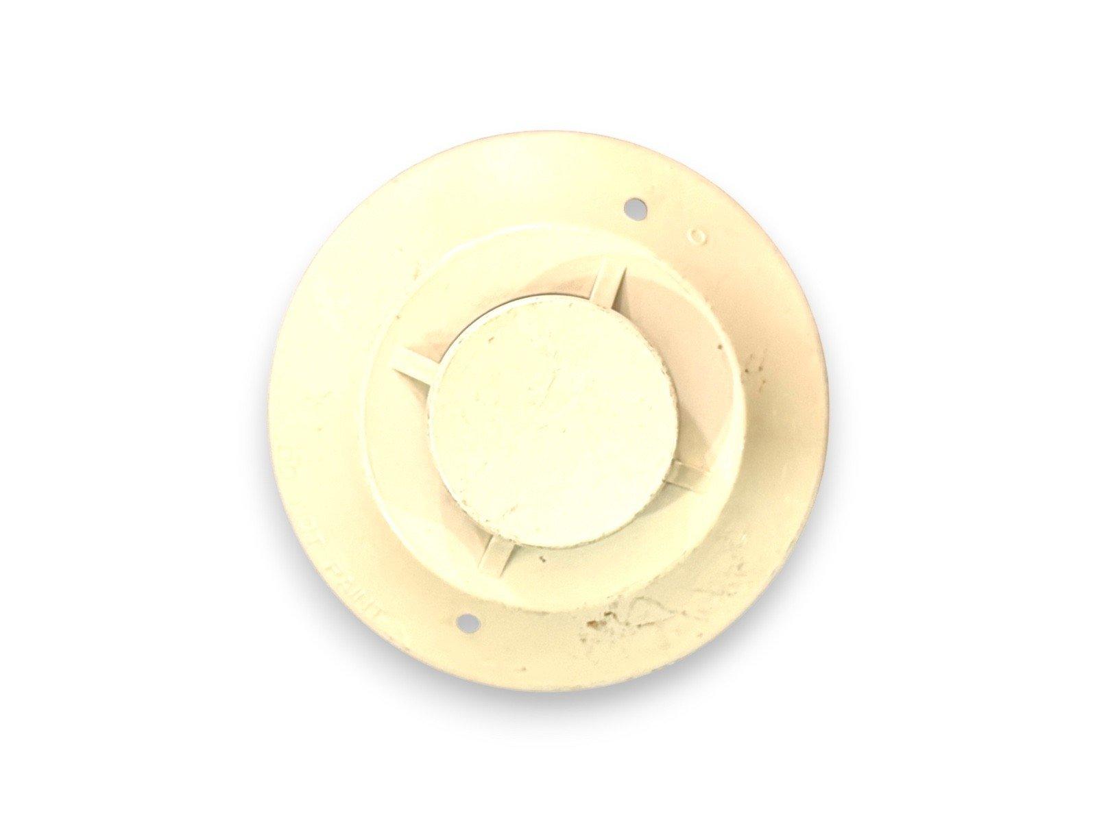 Used fire alarm base with mounting holes, off-white plastic for ceiling installation