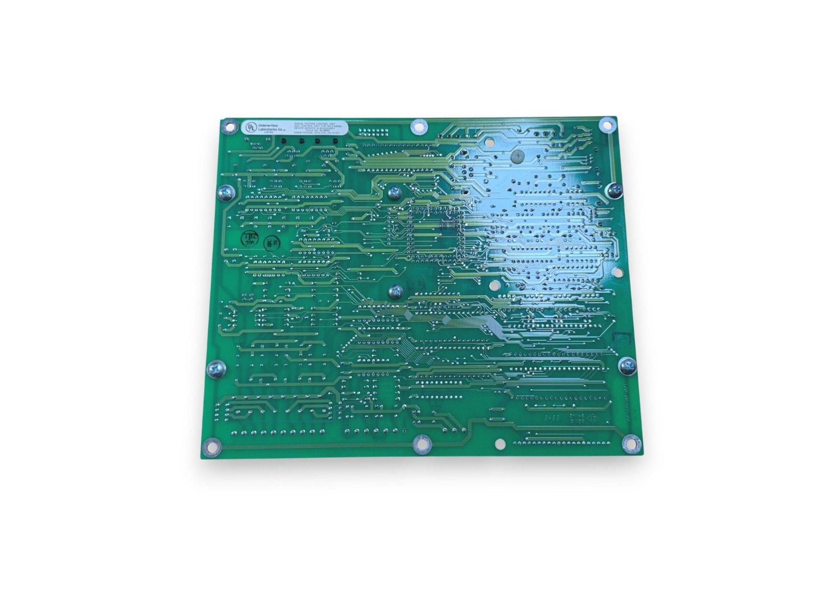Green fire alarm control panel circuit board with UL certification, used in fire safety systems.
