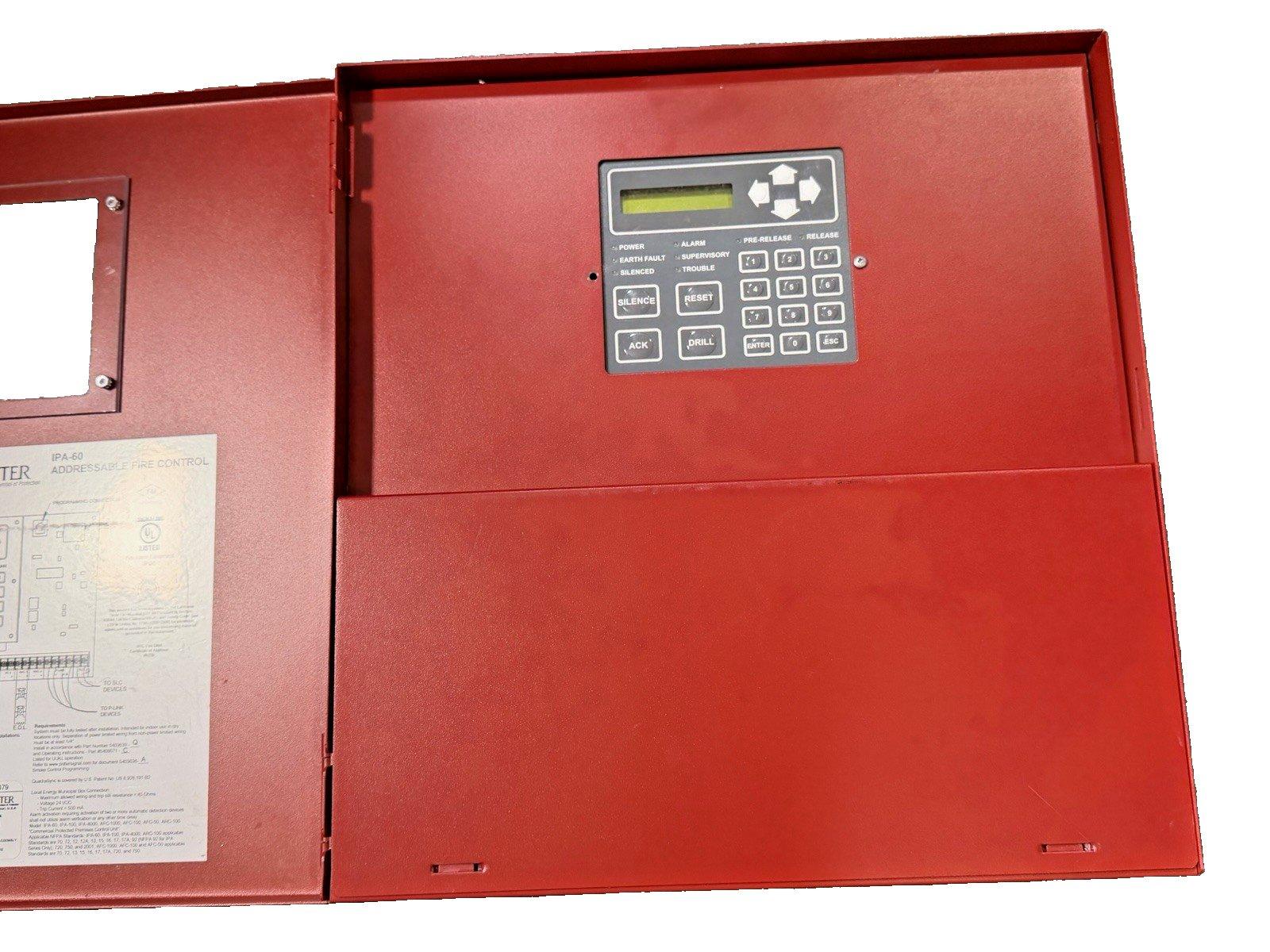 Red fire alarm control panel with digital display and keypad, labeled IPA-60 addressable system