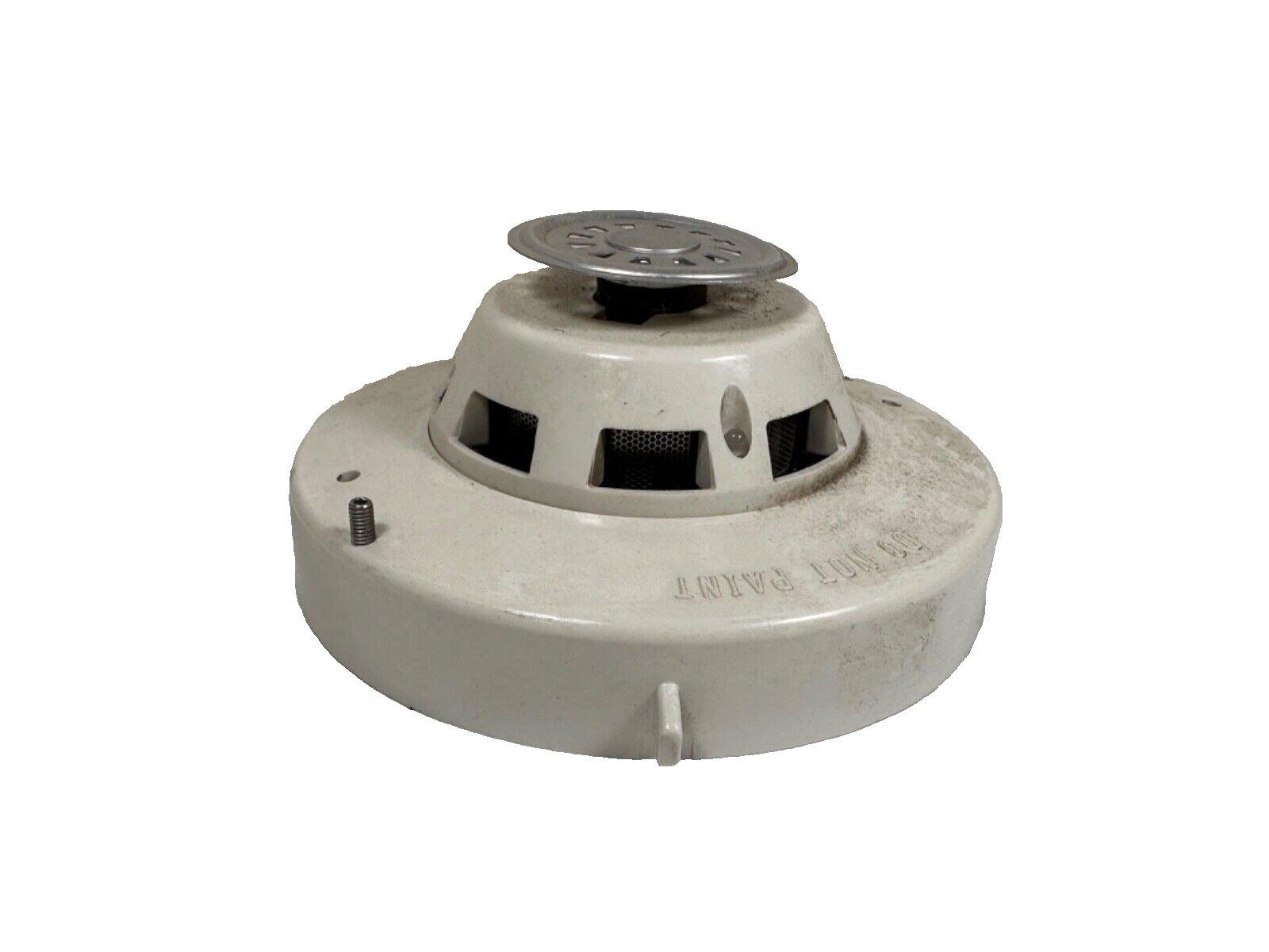 Used fire alarm smoke detector with metal cover and vented base, labeled 'DO NOT PAINT'