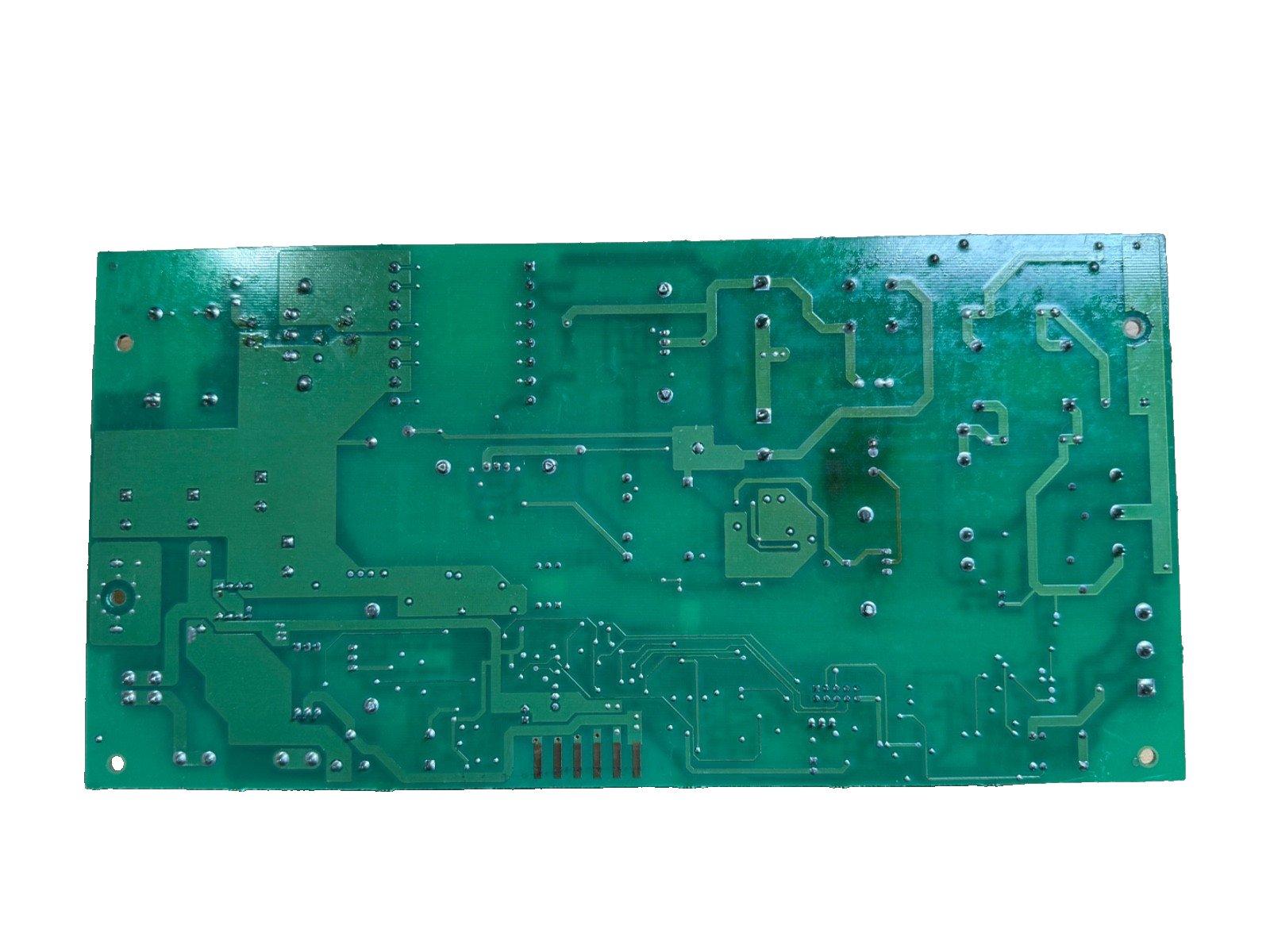Green fire alarm control panel circuit board with solder points and traces