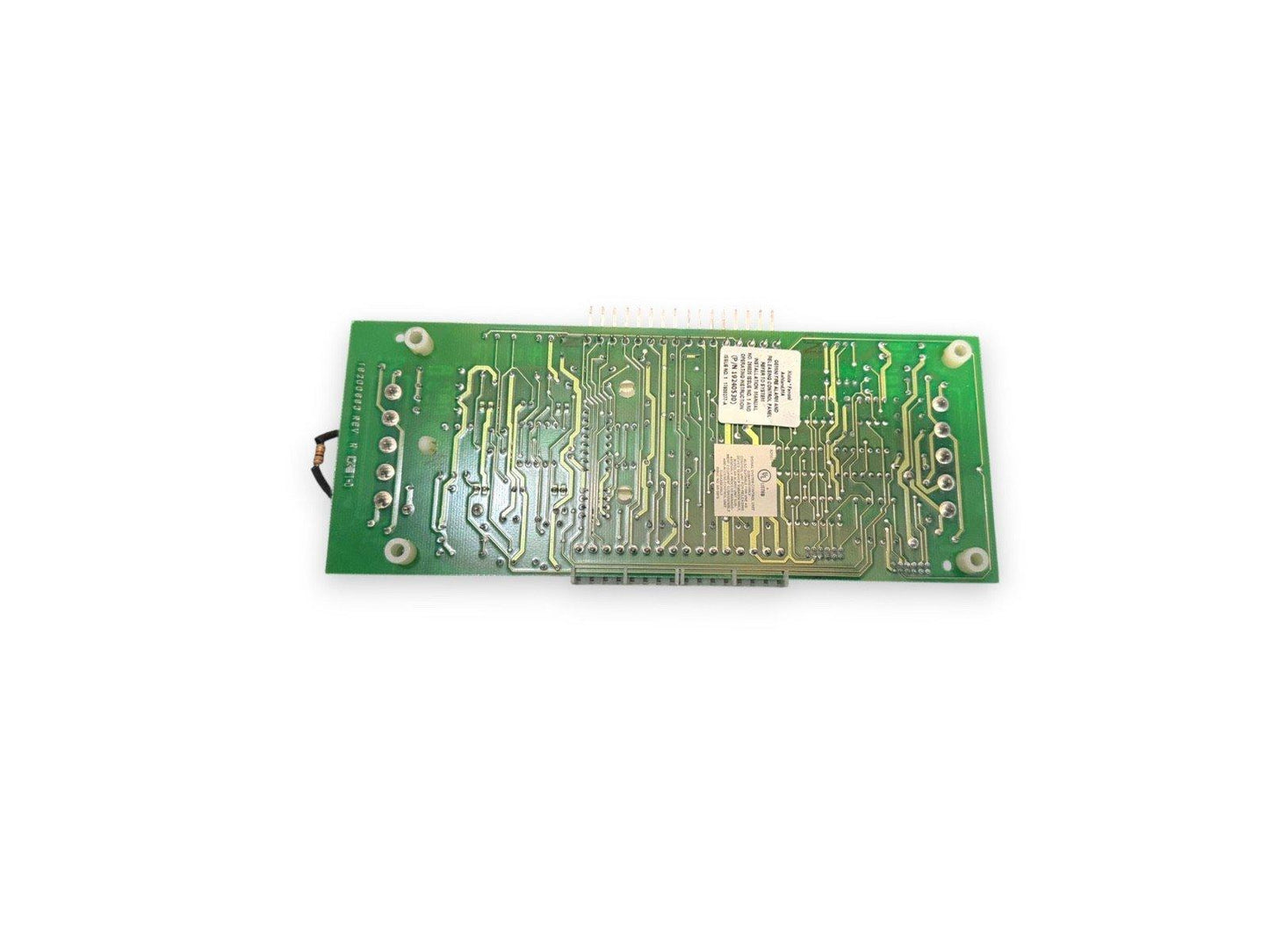 Green fire alarm control panel circuit board with connectors and labels for fire safety systems