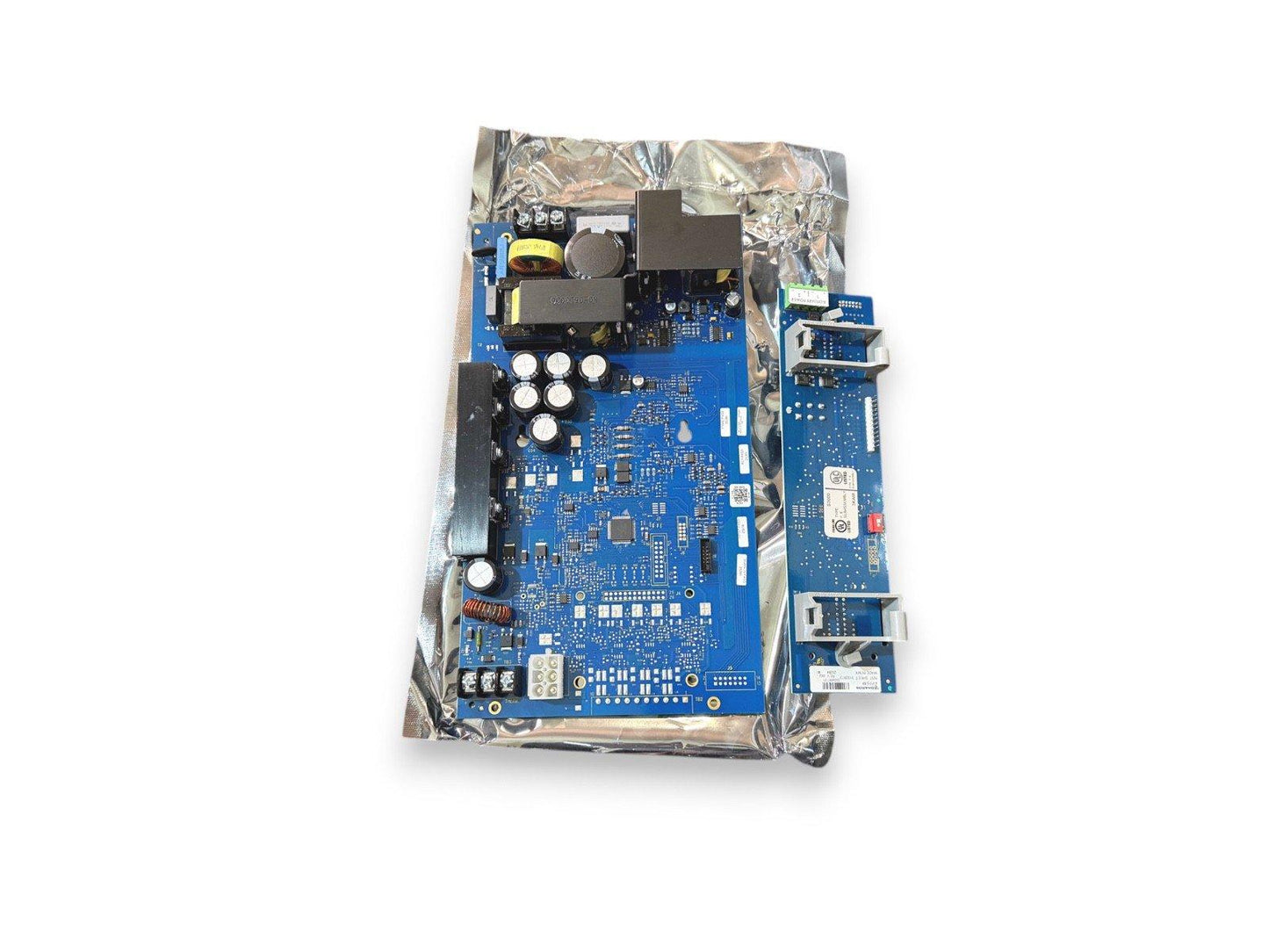 Blue fire alarm control panel circuit board with components, anti-static packaging