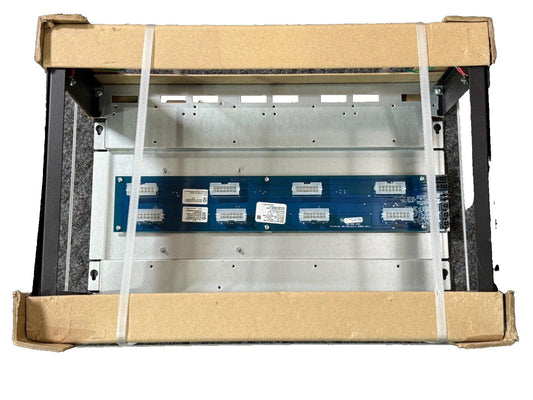 Fire alarm control panel circuit board inside metal enclosure, packaged for shipping