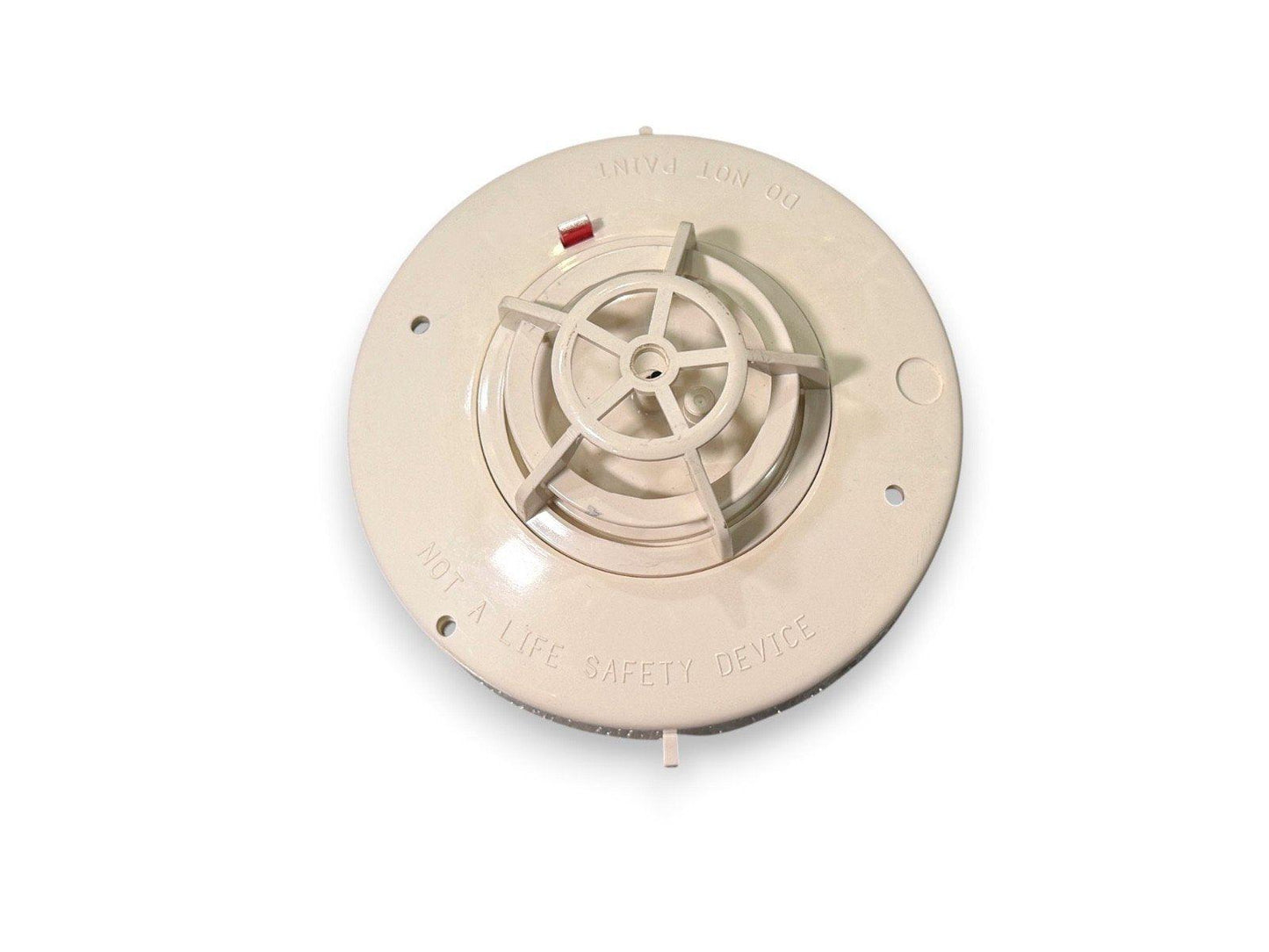 Beige ionization smoke detector base with red test button, labeled 'DO NOT PAINT' and 'NOT A LIFE SAFETY DEVICE'
