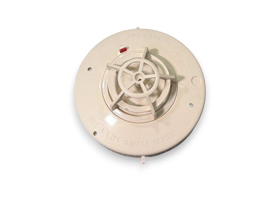 Beige ionization smoke detector base with red test button, labeled 'DO NOT PAINT' and 'NOT A LIFE SAFETY DEVICE'