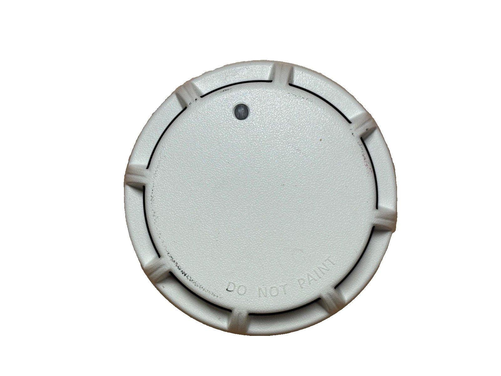 White fire alarm smoke detector with 'DO NOT PAINT' label, circular design, and central sensor