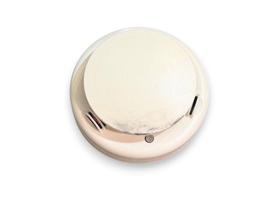 White smoke detector with test button, used fire alarm equipment