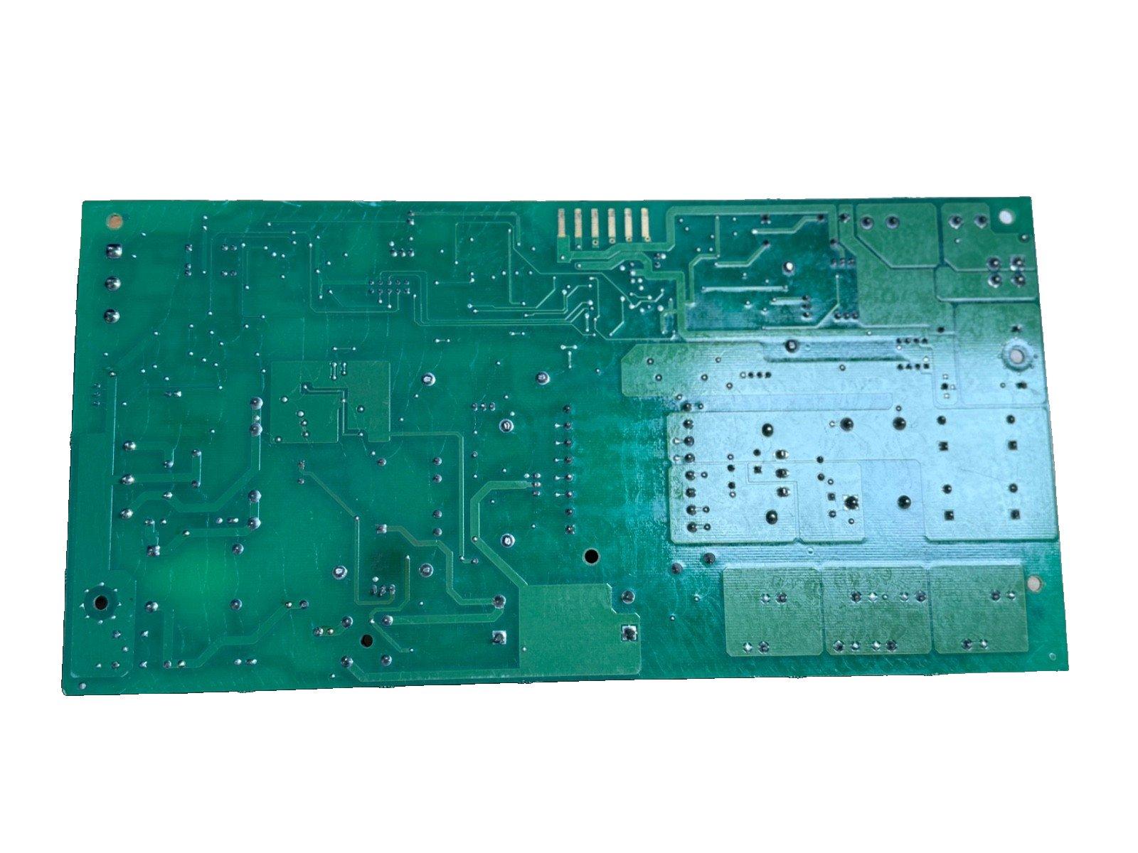 Green fire alarm control panel circuit board with solder points and traces