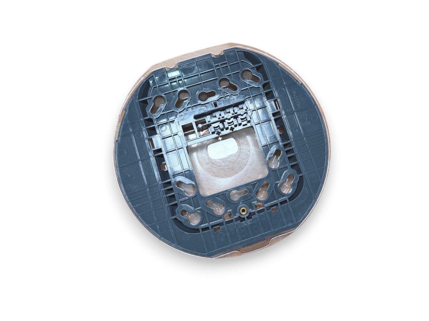 Circular fire alarm base with mounting holes and internal wiring connectors for commercial use