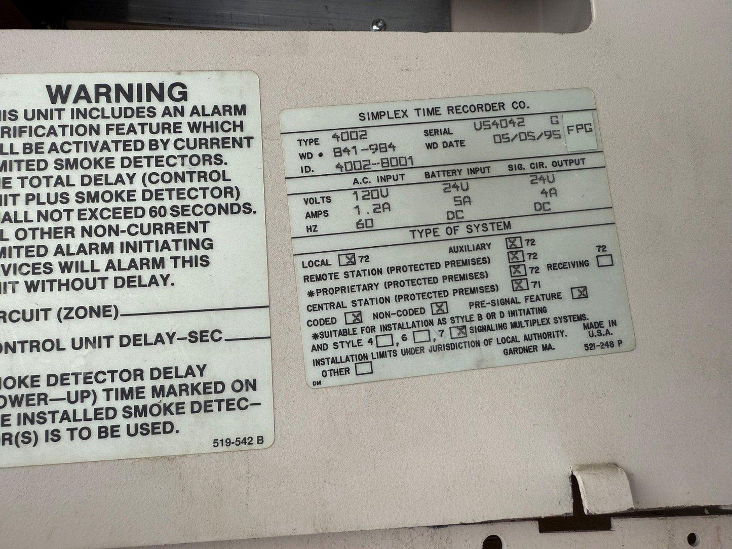 Simplex 4002 fire alarm control panel label with specs and warning for smoke detector delay