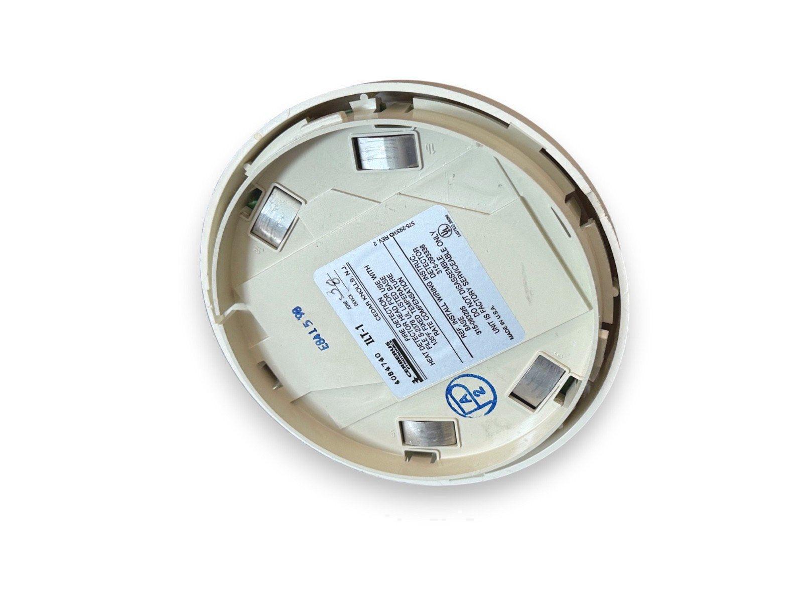 Fire alarm heat detector base with wiring terminals and label, for commercial or residential fire safety systems