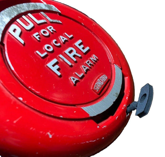 Red fire alarm pull station with 'PULL FOR LOCAL FIRE ALARM' text, used fire safety equipment