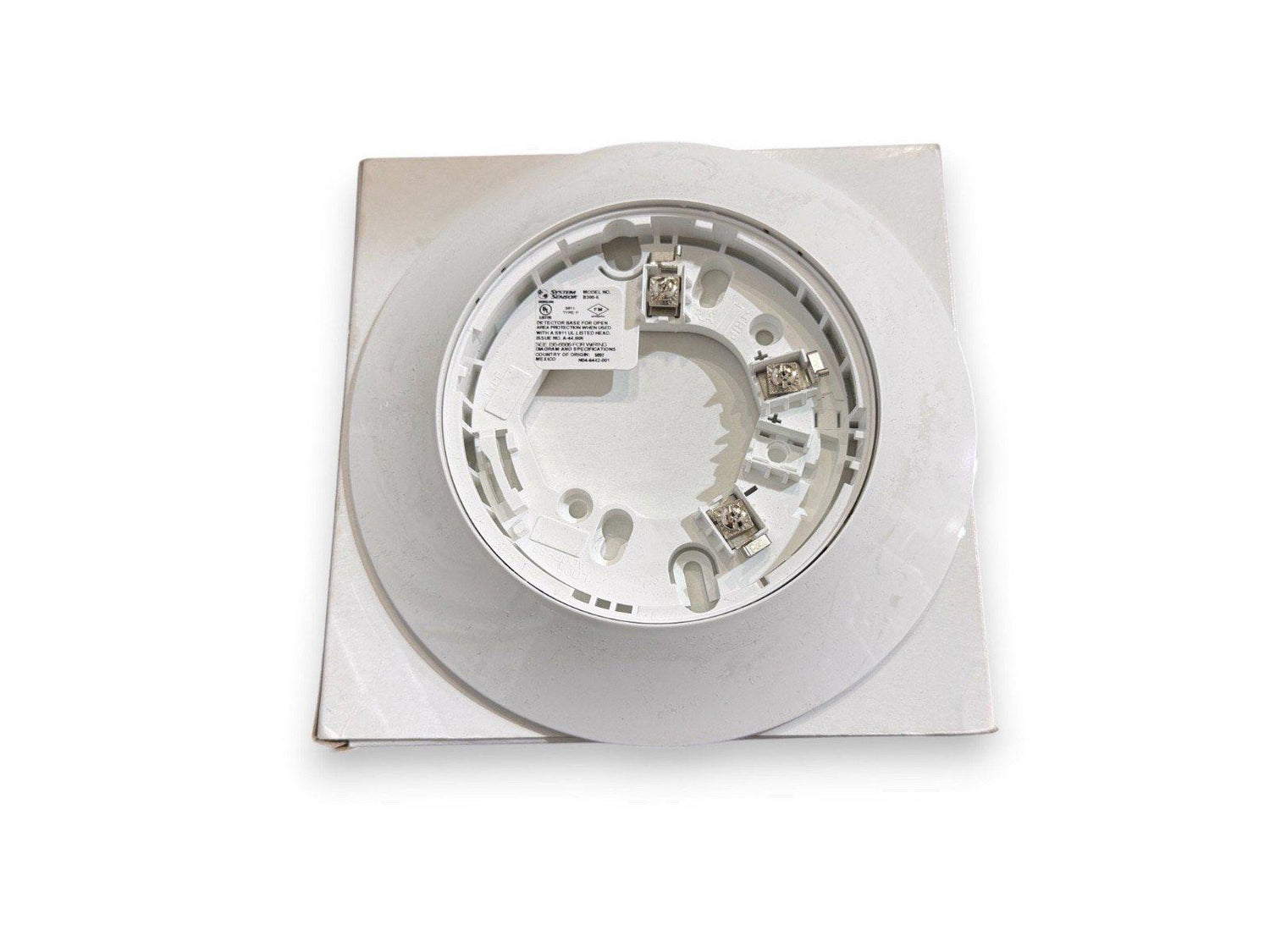 White fire alarm detector base with wiring terminals, compatible with System Sensor devices