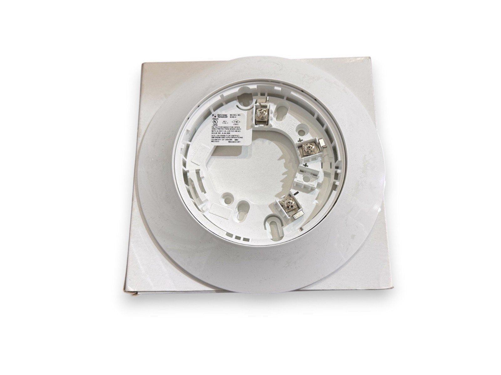 White fire alarm detector base with wiring terminals, compatible with System Sensor devices
