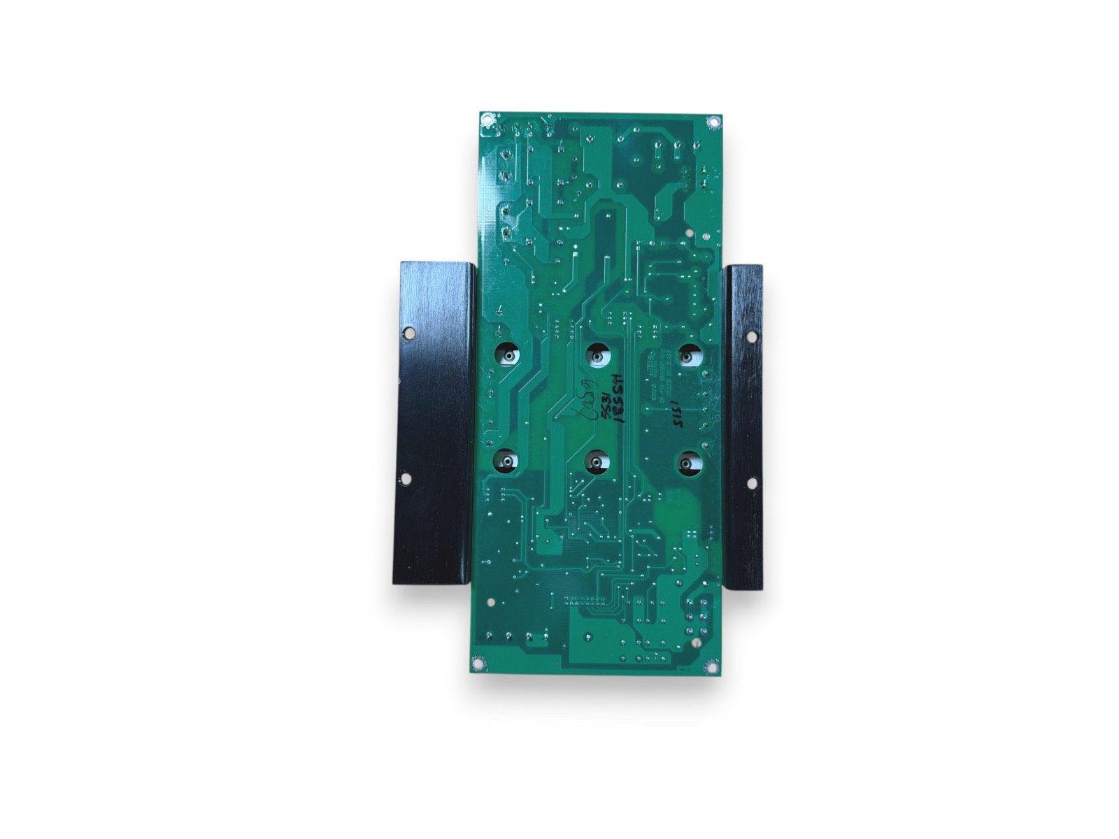 Green fire alarm control panel circuit board with mounting brackets, used fire safety equipment
