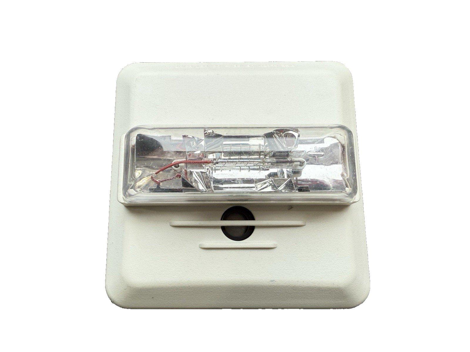 Green fire alarm control panel circuit board with solder points and traces for fire safety systems