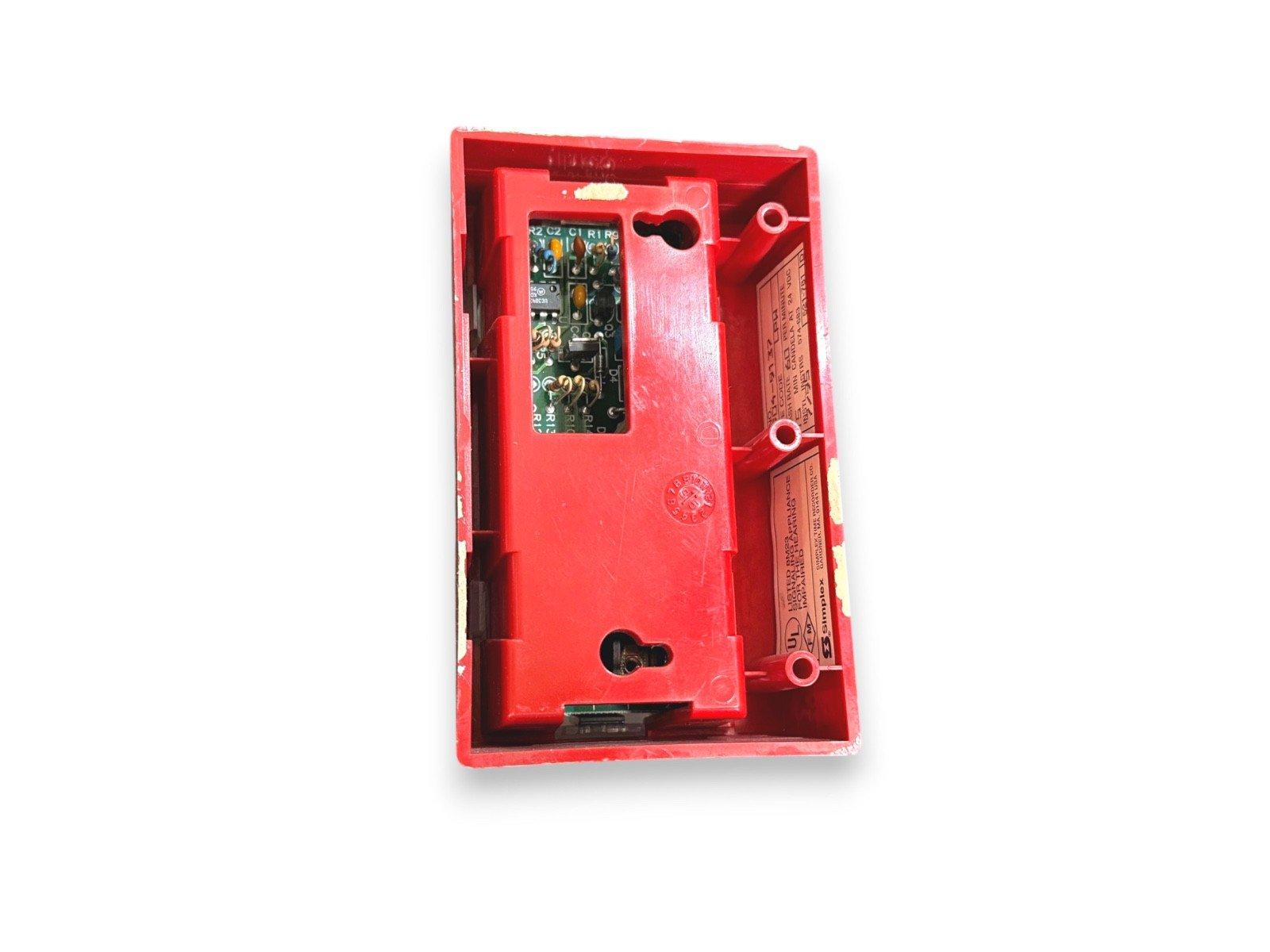 Red fire alarm pull station with exposed circuit board and wiring terminals