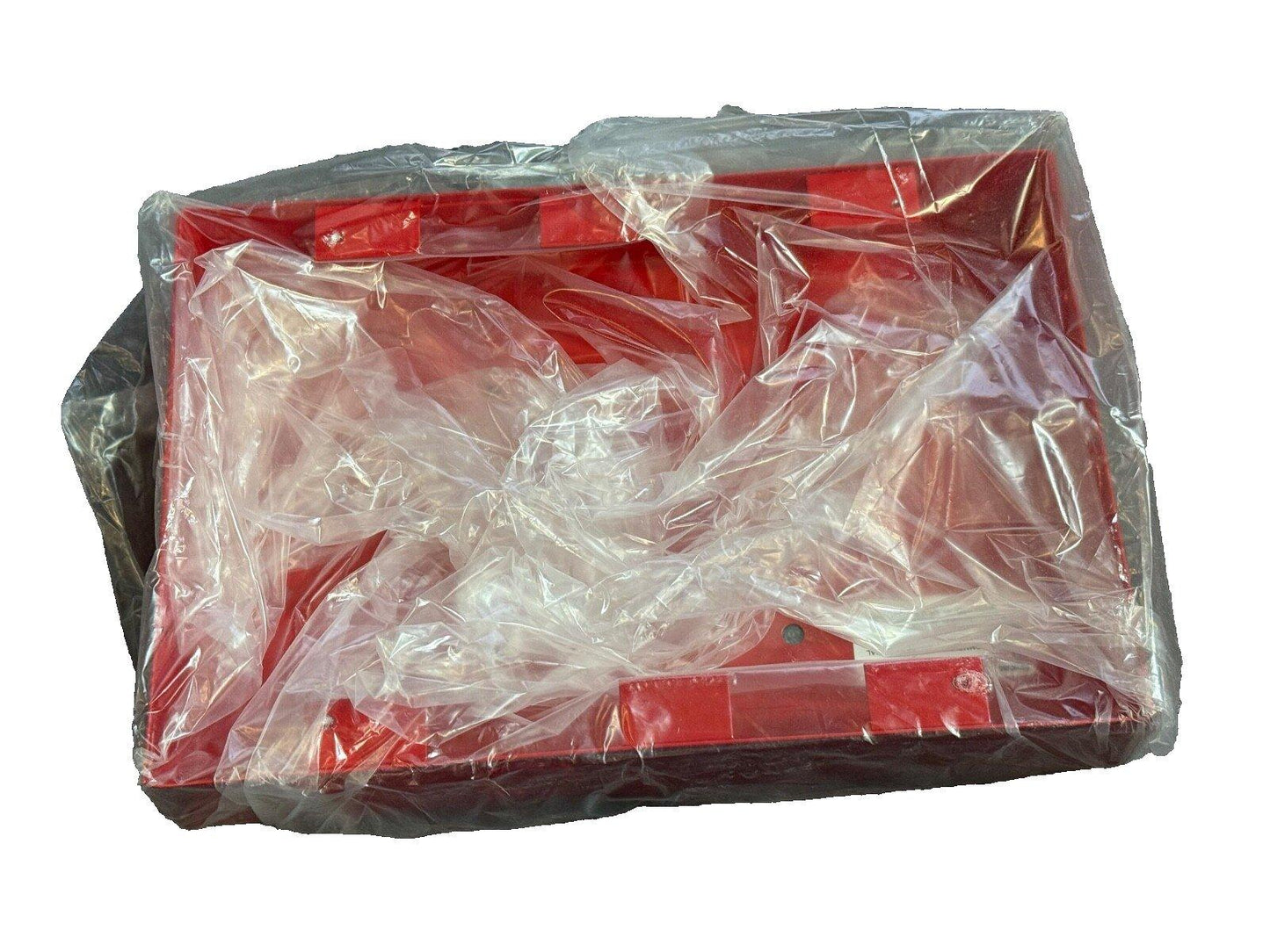 Red fire alarm control panel wrapped in plastic for shipping