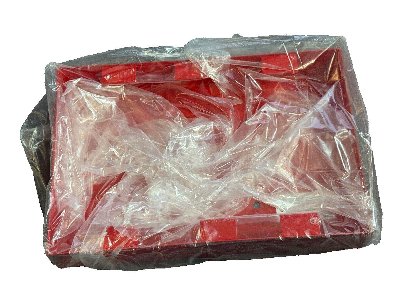Red fire alarm control panel wrapped in plastic for shipping
