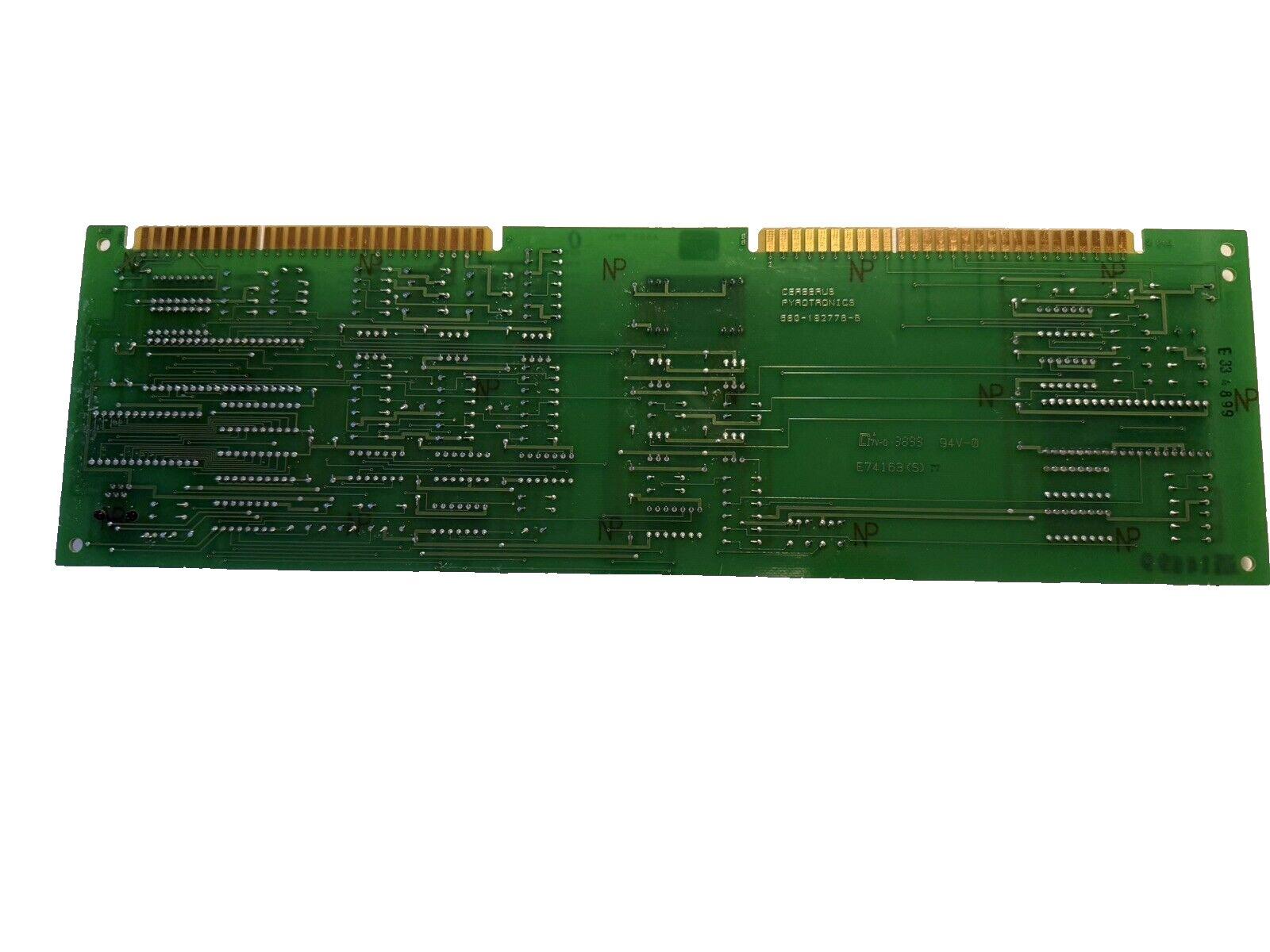 Green fire alarm control panel circuit board with gold connectors and printed labels