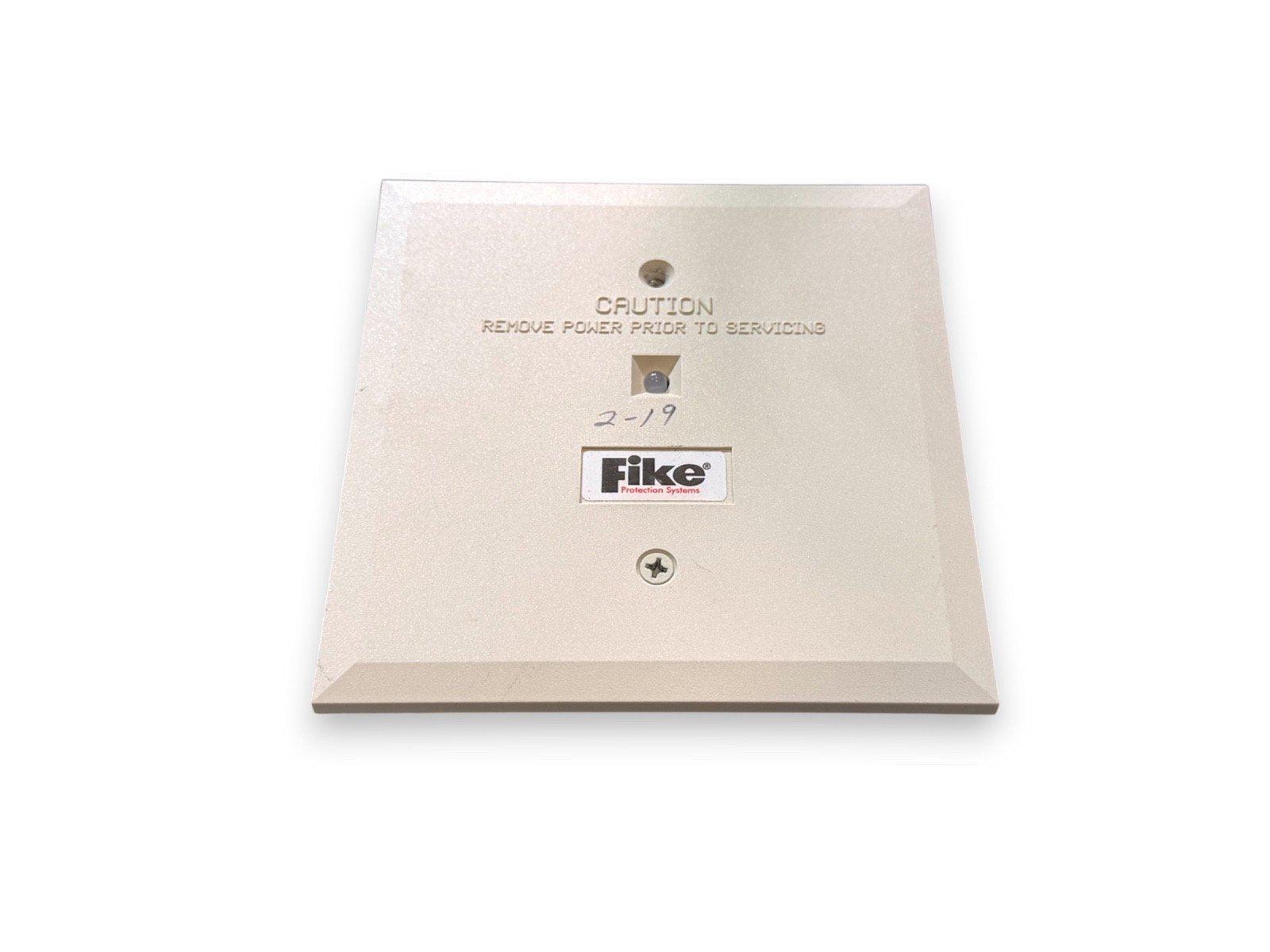 Fike fire alarm panel cover with caution label, used fire safety equipment