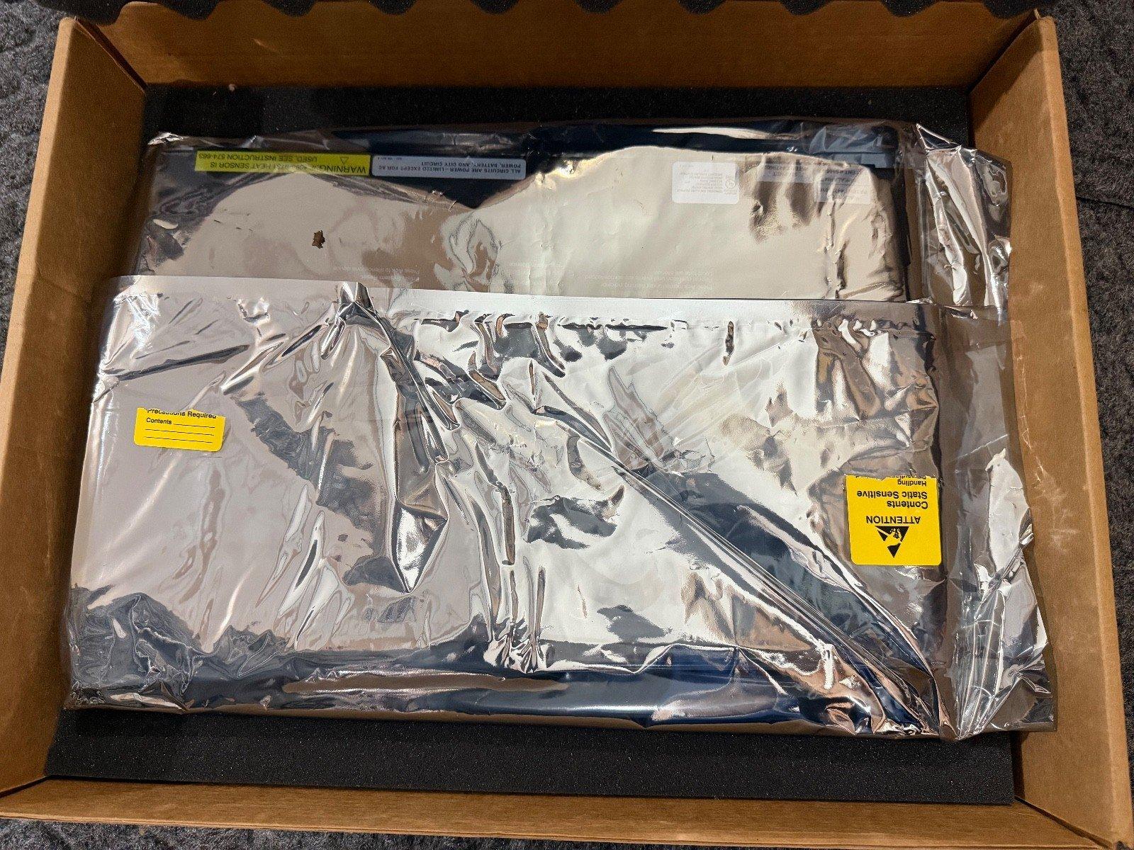 Fire alarm equipment in static-sensitive packaging inside cardboard box, ready for shipping