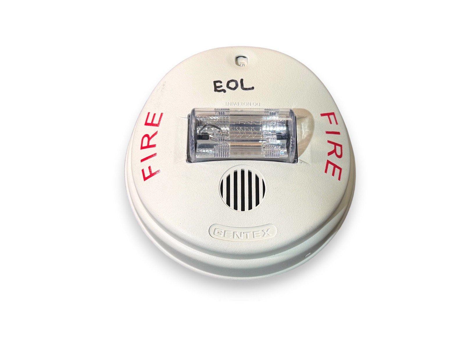 Gentex fire alarm with strobe light and EOL label, white round smoke detector for fire safety systems