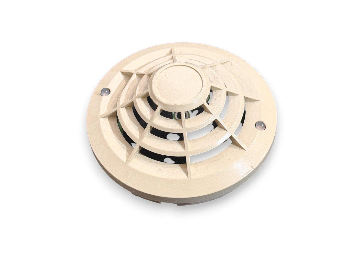 Beige ceiling-mounted fire alarm detector with vented cover and mounting screws