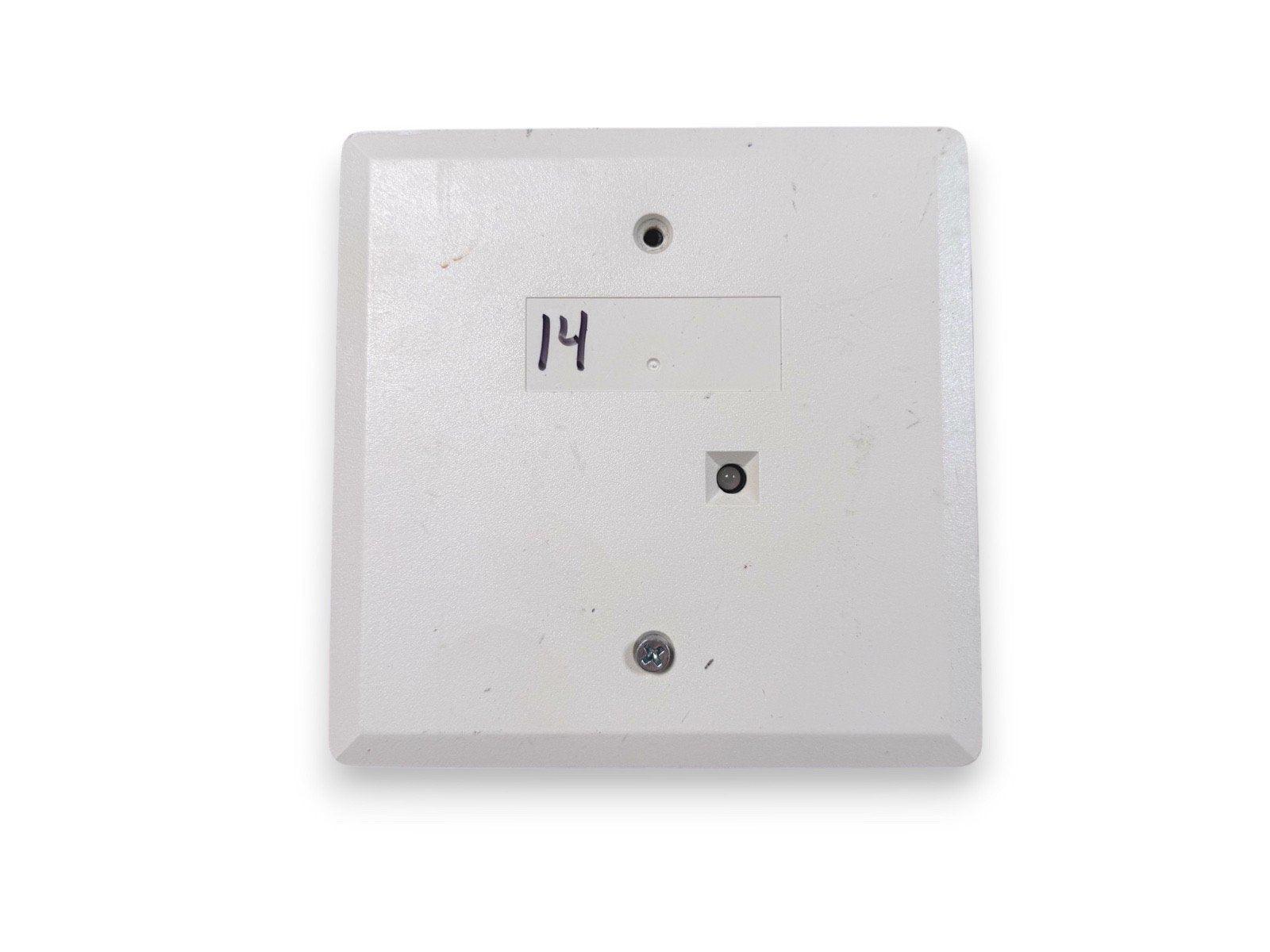 White fire alarm pull station with handwritten label 14, used fire safety equipment