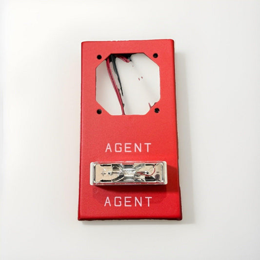 Red fire alarm pull station with 'AGENT' label and exposed wiring, for commercial fire safety systems