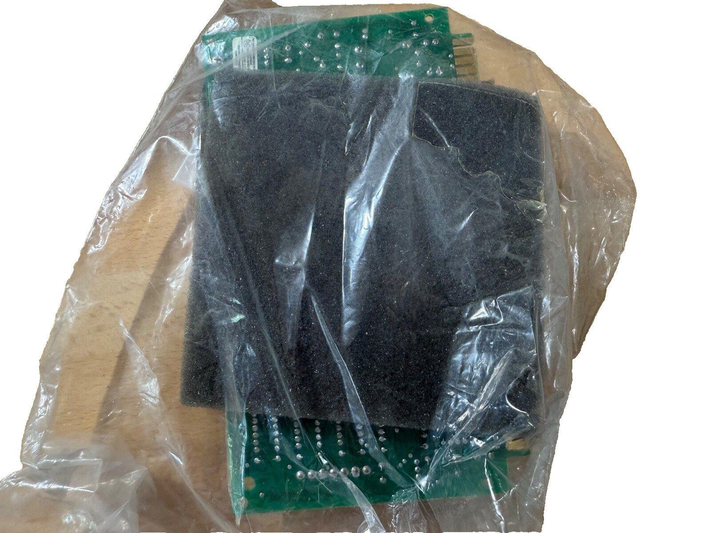 Fire alarm control panel circuit board in protective plastic wrap, used fire alarm equipment