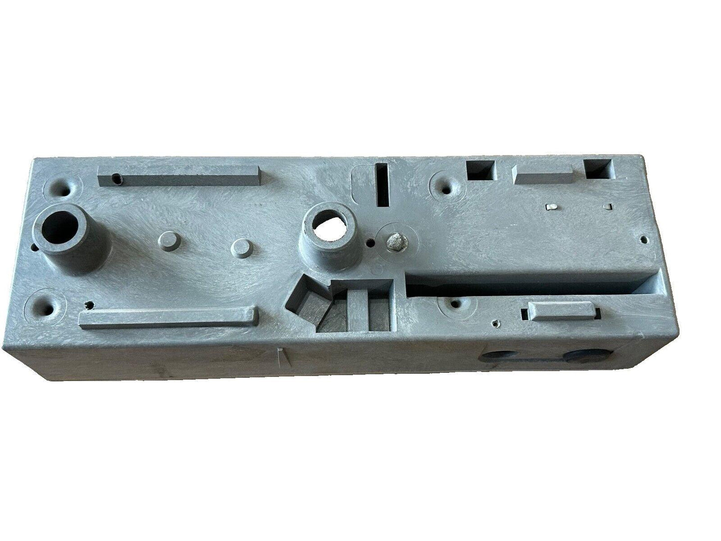 Gray metal fire alarm control panel housing with mounting holes and cutouts for wiring