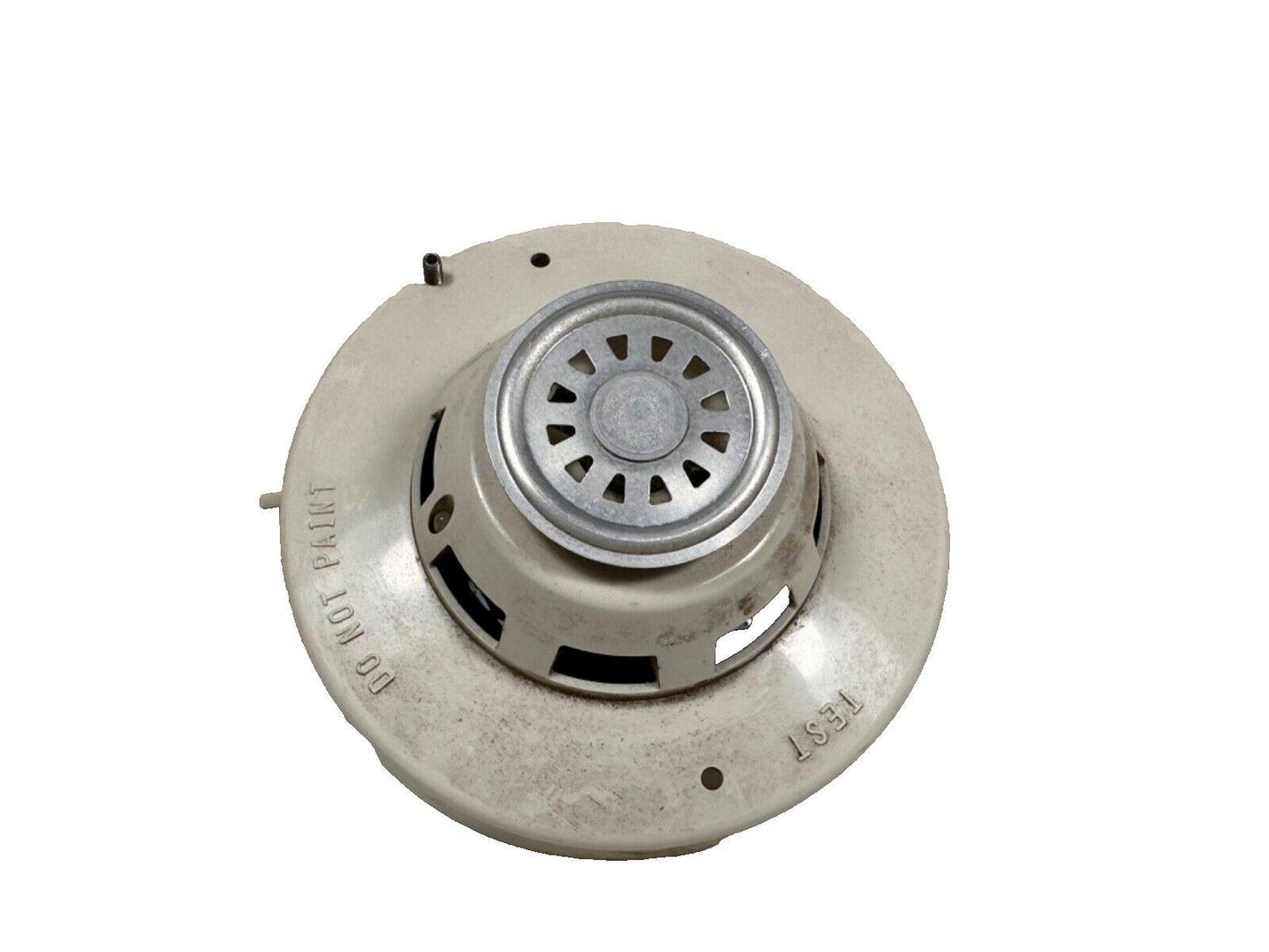 Used fire alarm smoke detector with test button and 'Do Not Paint' label, for fire safety systems