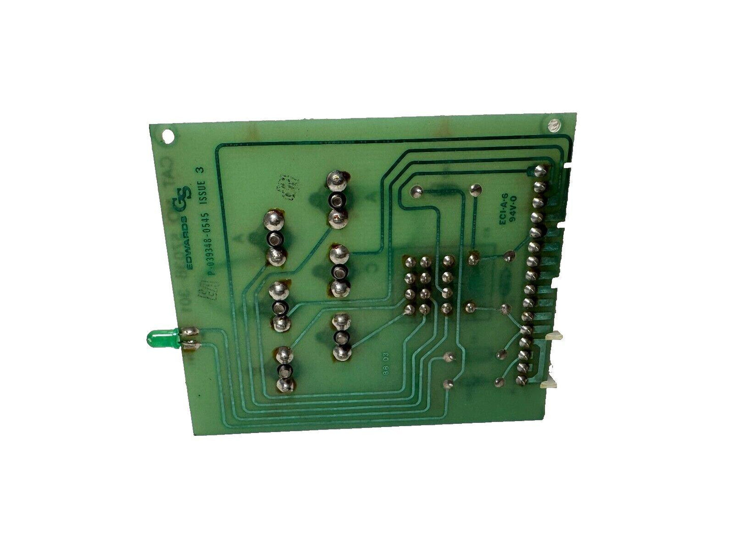 Green fire alarm control panel circuit board with soldered components and LED indicator