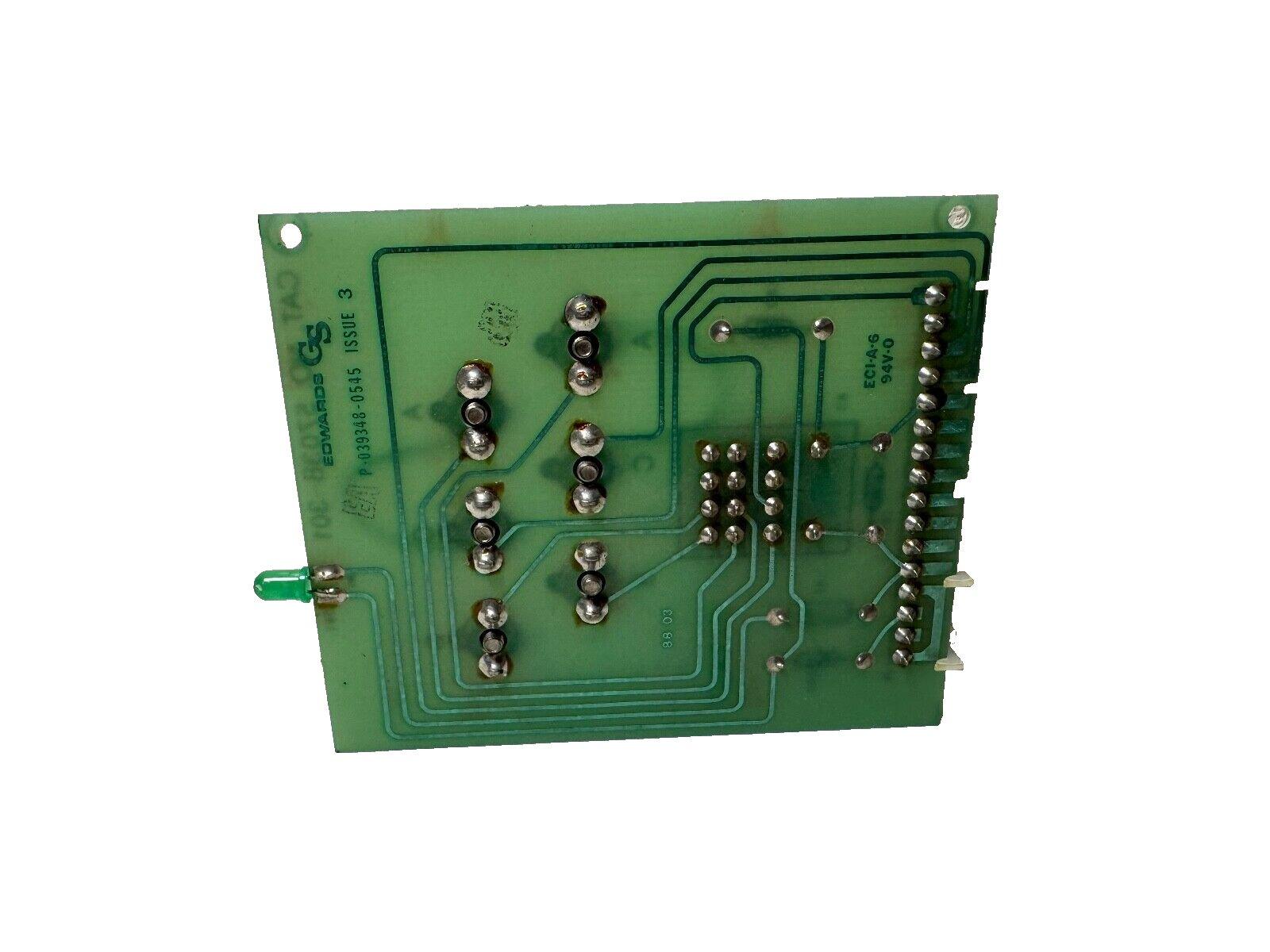 Green fire alarm control panel circuit board with soldered components and LED indicator