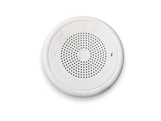 White circular fire alarm speaker with perforated grille, used fire safety equipment