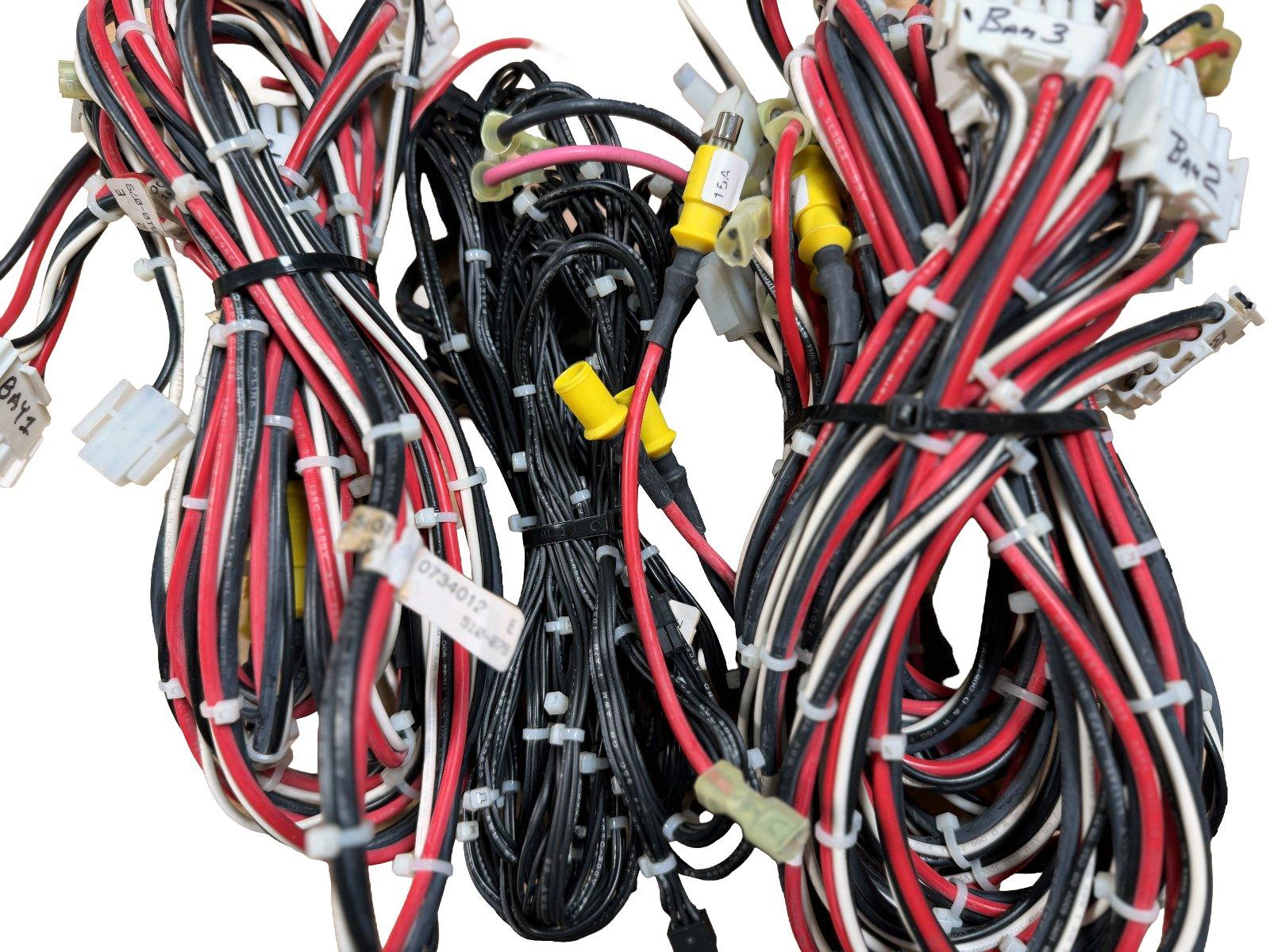 Fire alarm wiring harness with red, black, white cables, connectors, and labels for system installation